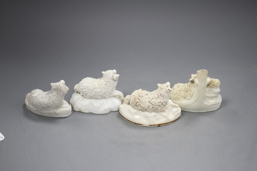 A Samuel Alcock porcelain figure of a recumbent ewe, an Alcock type ewe and two Staffordshire porcelain figures of sheep